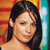 Pixelated close-up of a person with dark hair against a colorful striped background.