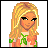 Pixelated image of a blonde woman with green eyes and dark eyeliner, wearing a pink top with green patterns on the sleeves.