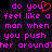 Pixelated text in bright pink on black background with red heart symbol replacing 'you' in 'do you feel like a man when you push her around?'