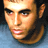 Pixelated close-up of a person's face with light skin tone, dark eyebrows, and visible facial features against a gradient background transitioning from blue to black.