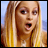 Static pixelated image of a person with long blonde hair against a light blue background, mouth open in an expressive pose.