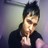 Pixelated static image of a person with dark hair wearing a black shirt, making a hand gesture near their face against a gradient background.