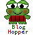 Pixelated green frog with large white eyes and black pupils, wearing red striped shirt, standing against gray background with 'Blog Hopper' text below.