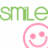 Green pixelated text 'smile' above a pink pixelated smiley face icon on white background.