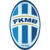 Oval-shaped pixelated icon with blue and white vertical stripes, two horizontal gold bands, and partially obscured text in the center.