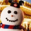 A snowman face with black button eyes, a carrot nose, and a mouth of small black buttons, wearing a black hat with a red circular emblem and a red-and-blue checkered scarf.