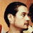 Static 48x48 pixel icon showing a close-up of a person's face with dark hair and light skin, rendered in low-resolution pixel art style against an orange-brown background.