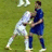 Two soccer players in white and blue uniforms grapple on a grassy field with blue text reading 'OWNED' on black backgrounds.