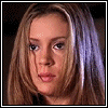 A pixelated animation of a woman's face transforming into a simplified cartoon style with red lips and blue eyes against dark backgrounds.