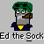 Pixelated character with green hair, gray face, brown pipe, blue jacket, yellow chest emblem, and white mustache on light gray background.