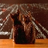 A pixelated static image shows a figure in dark clothing against a blurred background with light streaks.