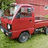 Red pickup truck on grass with green foliage background, shown in four views across a