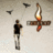 Static 48x48 pixel icon showing a stick figure and an airplane with fire, set against a light gray background.
