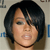 Pixelated close-up of a person with short dark hair and light skin, wearing a dark choker necklace against a light background with blue and gray elements.