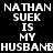 Pixelated text repeats 'NATHAN SUEK IS MY HUSBAND' across a black background with partial gray overlay.