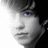 Pixelated grayscale portrait of a person with light hair and blue eyes, overlaid with cyan text reading 'my true love' and 'kevin michael mchale'.