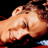 Pixelated close-up of a person's face with visible skin tones and partial facial features against a dark background.