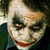 A pixelated image of a character with white face paint, dark smudged eye makeup, and red lips in three sequential views showing slight head movement.