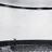 A static grayscale image with horizontal bands of varying gray tones and a small dark pixel cluster near the bottom center.