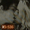 A static image of a person with dark hair and light skin in profile, wearing a dark top, with orange text 'X5-536' overlaid on a dark background.
