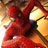 Pixelated static image of a red and yellow figure with indistinct facial features, likely a cartoon character in motion against a blurred background.
