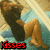 Animated pixel art of a character lying on their side with legs bent, transitioning from 'Kisses' text to 'Mwah' text.