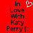 Red background with black text reading "In Love With Katy Perry [:" and a white pixelated heart symbol above the text.
