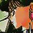 Pixelated static image shows a character with brown hair holding an orange rectangular object against a dark background with green and white elements.