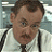 Static pixelated image of a person with short brown hair wearing a white shirt and dark suspenders against a blurred background.