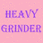Pixelated image with pink background, purple text 'HEAVY GRINDER', and a person holding dark object.