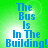 Green background with blue pixelated text reading 'The Bus Is In The Building!' arranged in a vertical stack.
