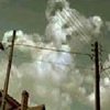Static image of a cloudy sky with two utility poles and power lines, rendered in low-resolution pixelated style.