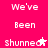 Pixelated text on bright pink background with white lettering, showing repeated phrases and star symbols in two