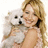 A static image shows a person with light brown hair holding a small white dog against a plain background.