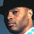 Pixelated profile image of a person wearing a black cap and light blue shirt, next to bold text reading 'COWBOY TROY' with pink accents.