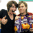 Two people pose together with one giving a peace sign, next to a pizza slice and text reading "DOOREETZ" and "PEETZ."