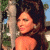A pixelated image of a woman with long dark hair leaning against a tree, next to green text reading 'Original Icons .com' on a solid background.