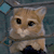 Pixelated image of a light brown cat with white chest and paws, dark eyes, and a neutral expression against a blue-gray background.
