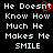 Black background with white pixelated text reading "He Doesn't Know How Much He Makes Me SMILE" and a red pixelated heart symbol replacing the 'o' in 'Doesn't'.