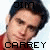 Two side-by-side pixelated images of a person with dark hair wearing a red shirt, with text overlays showing 'JIM' above and 'CARREY' below in blocky font.