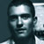 Pixelated static image of a person's face with high-contrast lighting and grayscale tones, displayed as a 50x50 buddy icon on a dark background.