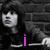 Two side-by-side show a person with long hair against brick and plain backgrounds, featuring colored text overlays