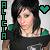 Pixelated image of a person with dark hair wearing a dark top, with a green heart symbol and vertical text on the left side.