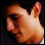 A pixelated image of a person's profile with visible ear and neck, transitioning to a green-to-yellow gradient background with the word 'shy' in black text.