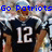 Pixelated image of a football player in dark blue jersey with number 12, raising both arms while text "Go Patriots Tom Brady" appears above.