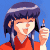 Pixelated anime-style character with dark blue hair and red top holding a pen-like object against split background of solid blue and green.