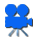 Blue film camera icon with gray legs, white lens area, and black outline on white background.