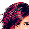 A close-up of a person's head showing dark hair with bright red streaks, partially obscuring the face against a white background.