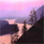 Pixelated landscape with pink and purple sky, dark blue water, and brown rocky terrain under a gradient horizon.