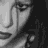 Black-and-white pixelated animation of a woman's face with tears, accompanied by text fragments on dark background.